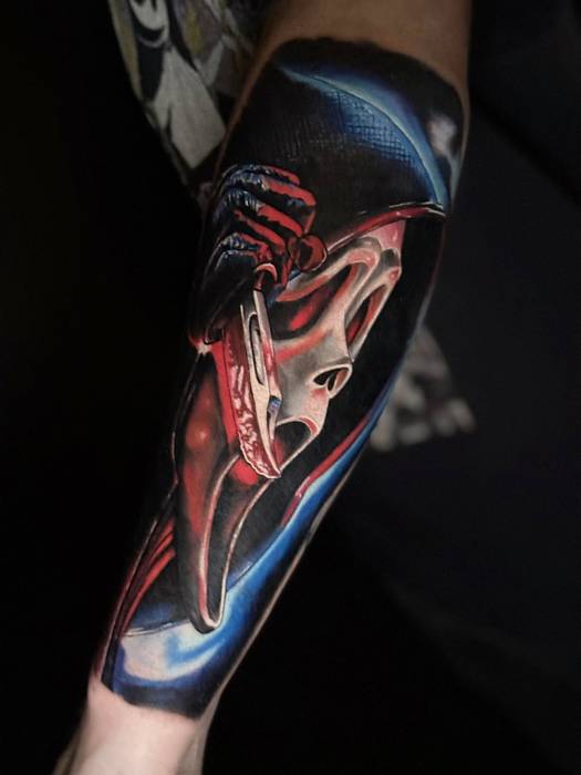 High-contrast red, white, and blue mask tattoo by Justin Styndl
