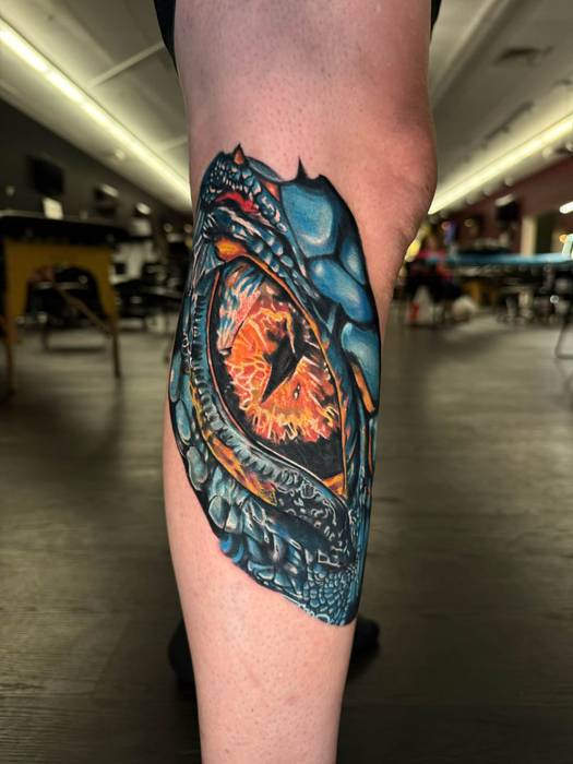 Vivid blue and orange dragon tattoo by Justin Styndl